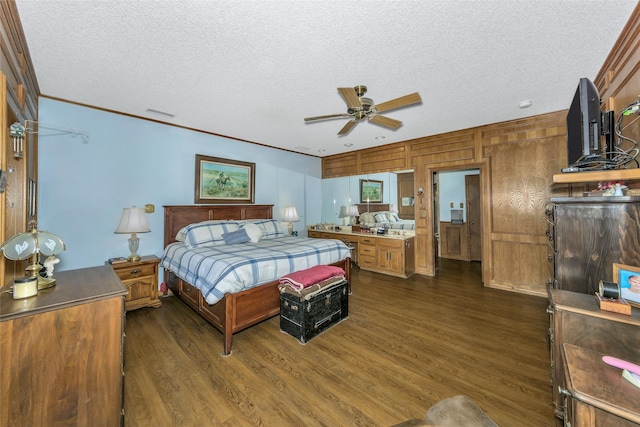 bedroom with dark wood-type flooring, visible vents, crown molding, and a textured ceiling