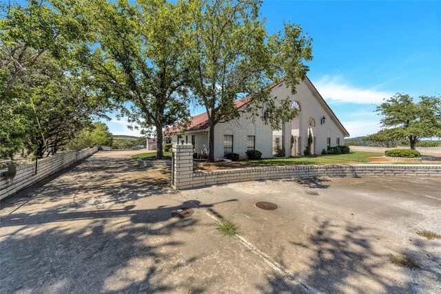 view of front of property with brick siding and fence