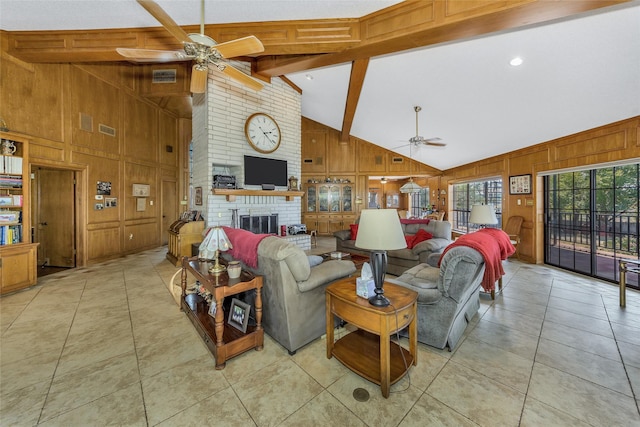 living area with light tile patterned floors, wooden walls, a ceiling fan, lofted ceiling with beams, and a fireplace