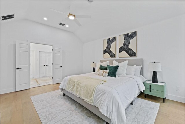 bedroom featuring lofted ceiling, light wood-style floors, and visible vents