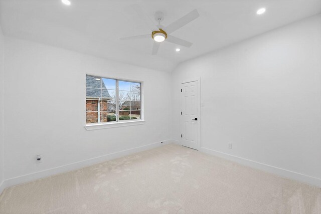 spare room with recessed lighting, lofted ceiling, light colored carpet, a ceiling fan, and baseboards