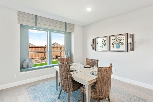 dining room with baseboards and wood finished floors