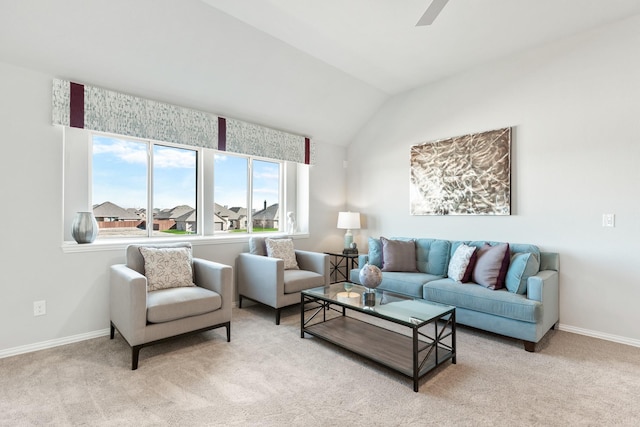 living area featuring light carpet, baseboards, and vaulted ceiling