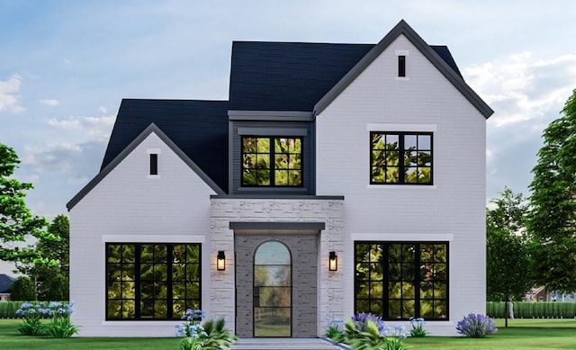 view of front of house with stone siding, brick siding, and a front yard