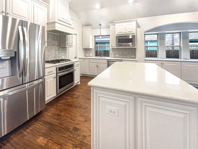 kitchen featuring appliances with stainless steel finishes, white cabinets, and a kitchen island