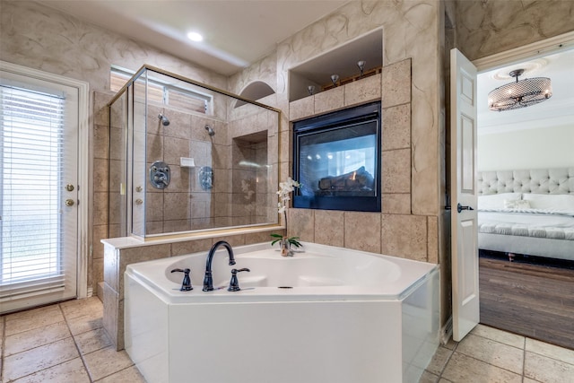 full bathroom with a shower stall, connected bathroom, a bath, and tile walls