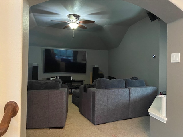 home theater room with a ceiling fan and vaulted ceiling