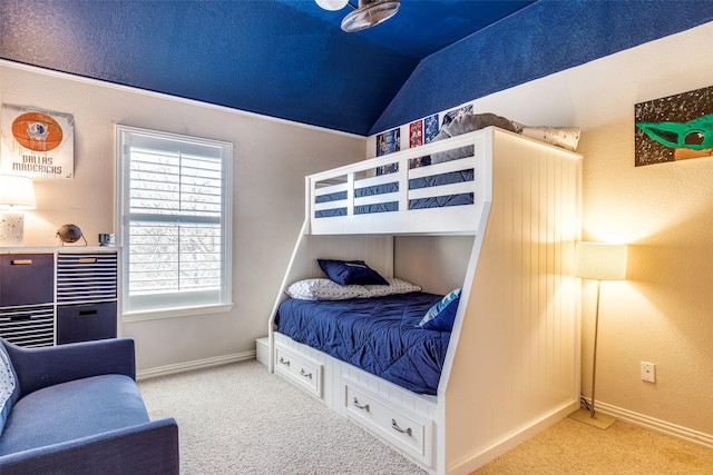 carpeted bedroom featuring lofted ceiling and baseboards