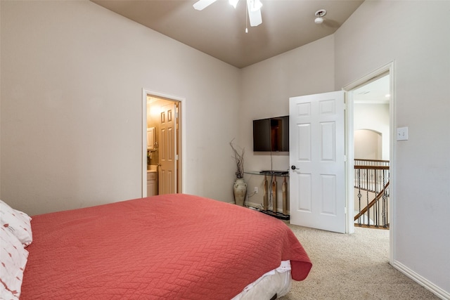 carpeted bedroom with connected bathroom, a ceiling fan, and baseboards