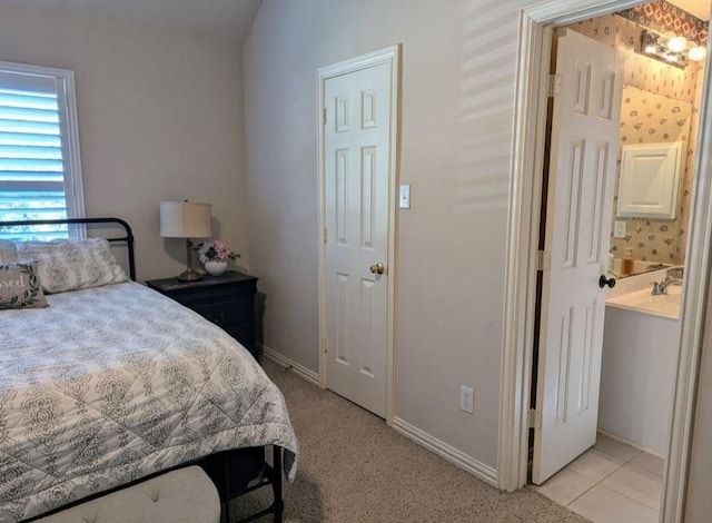 bedroom with light tile patterned floors and baseboards