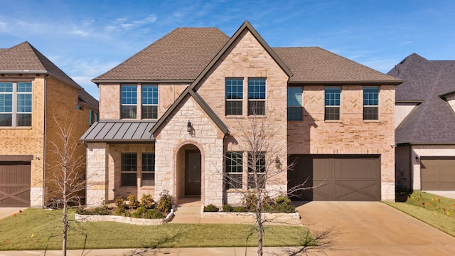 view of front of house with metal roof, brick siding, driveway, roof with shingles, and a standing seam roof