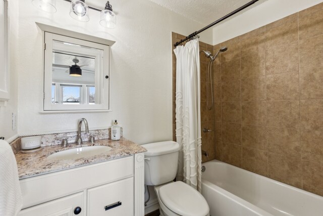 full bath featuring a textured ceiling, shower / bathtub combination with curtain, toilet, and vanity