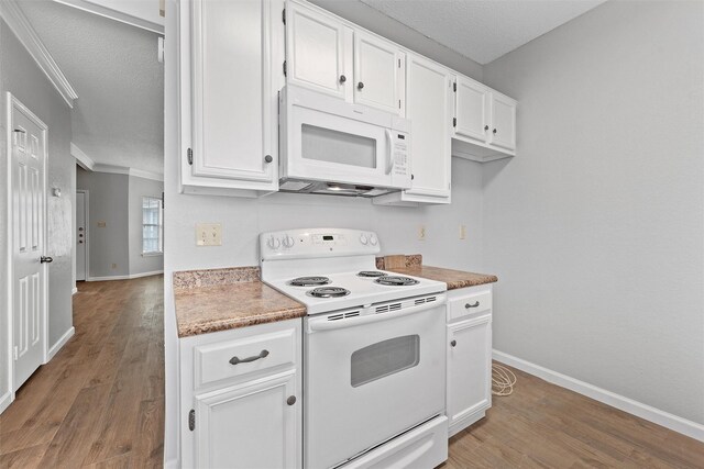 kitchen featuring crown molding, white appliances, baseboards, and white cabinets