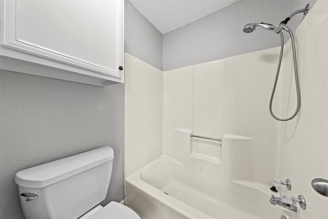 full bath featuring a textured ceiling, shower / bathing tub combination, and toilet