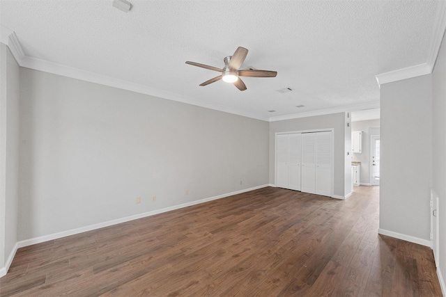 unfurnished bedroom featuring baseboards, visible vents, ornamental molding, dark wood-type flooring, and a textured ceiling