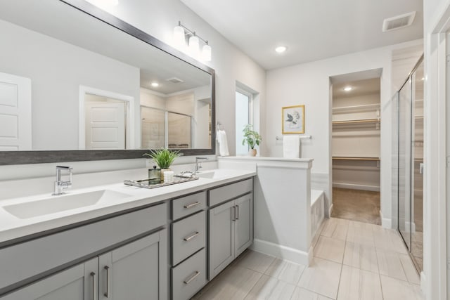 2417 Robin Way, Northlake, TX 76247 - bathroom with a stall shower, a spacious closet, double vanity, recessed lighting, and tile patterned flooring