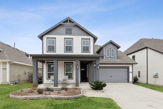 view of front of house with driveway, a porch, board and batten siding, and a front yard