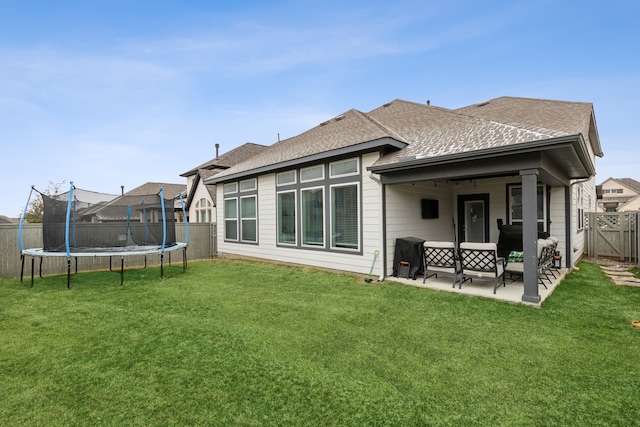 2417 Robin Way, Northlake, TX 76247 - back of house with a trampoline, a patio area, roof with shingles, and an outdoor hangout area