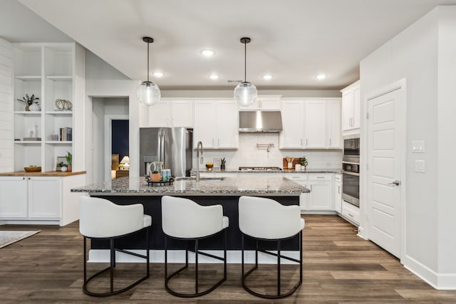 2417 Robin Way, Northlake, TX 76247 - kitchen with appliances with stainless steel finishes, under cabinet range hood, a sink, tasteful backsplash, and white cabinets