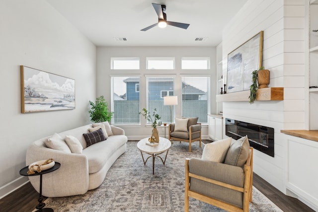 2417 Robin Way, Northlake, TX 76247 - living room featuring dark wood finished floors, ceiling fan, a glass covered fireplace, and baseboards