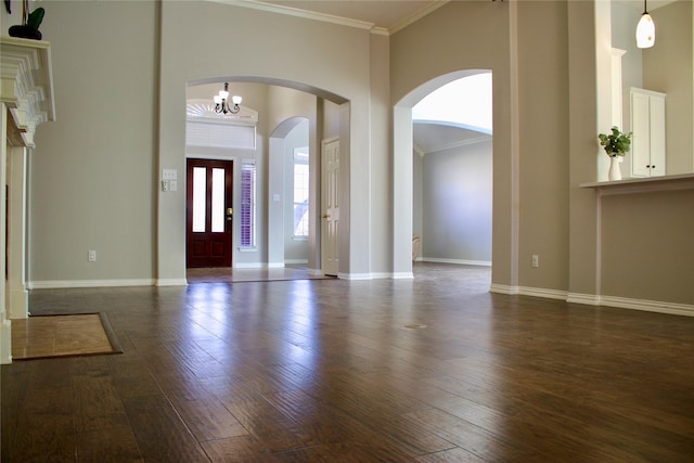 foyer featuring crown molding, a high ceiling, baseboards, and dark wood-style flooring