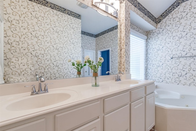 full bath featuring double vanity, a sink, a whirlpool tub, and wallpapered walls