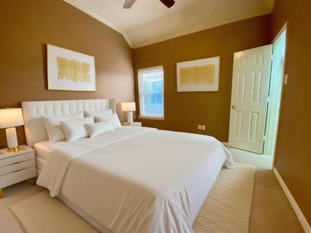 bedroom featuring light colored carpet, a ceiling fan, baseboards, vaulted ceiling, and crown molding