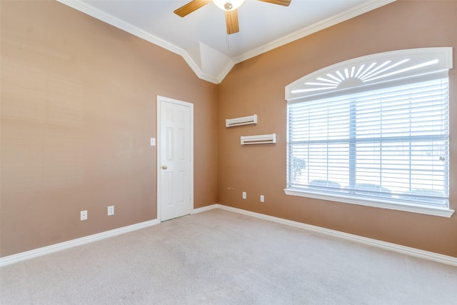 empty room with ceiling fan, carpet, baseboards, and crown molding