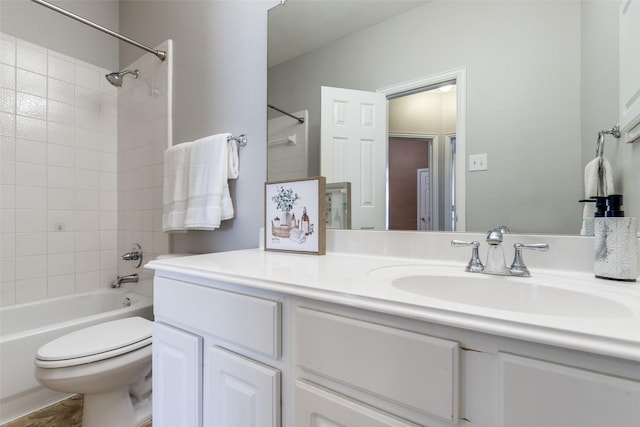 bathroom featuring bathtub / shower combination, vanity, and toilet