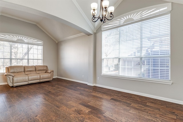 unfurnished living room with dark wood-style flooring, a notable chandelier, lofted ceiling, ornamental molding, and baseboards