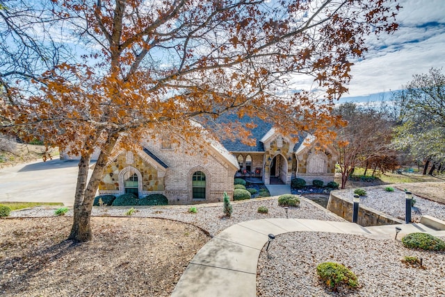 view of front facade featuring stone siding and brick siding