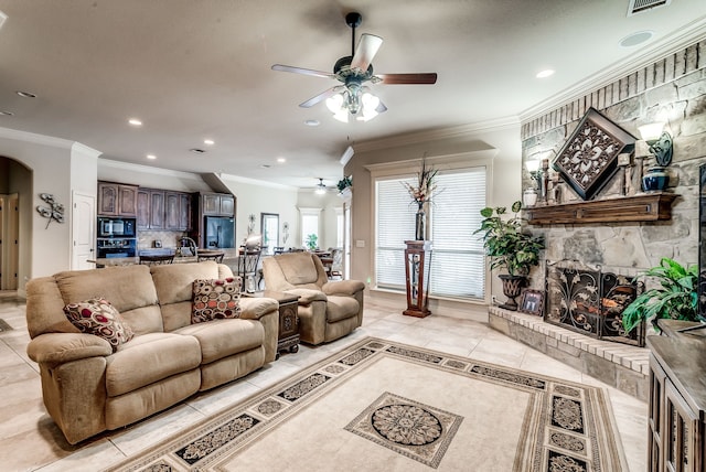 living room featuring ornamental molding, a fireplace, and light tile patterned floors