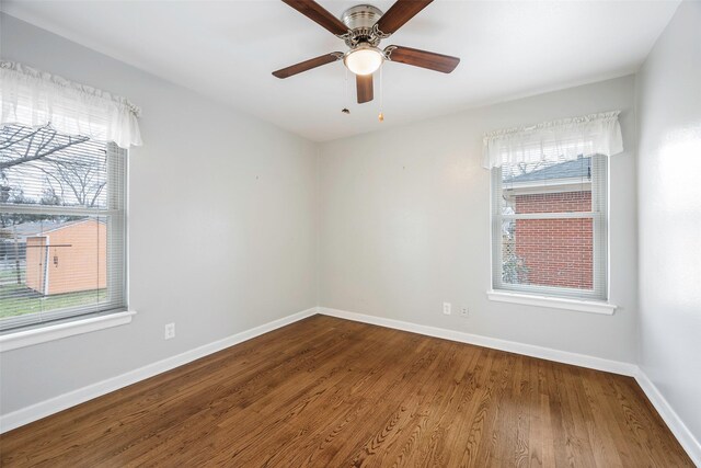 unfurnished room with a ceiling fan, baseboards, and wood finished floors