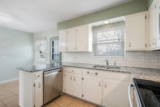 kitchen featuring white cabinets, dishwasher, a peninsula, and a sink