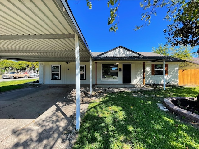 single story home with a carport, a front yard, and fence