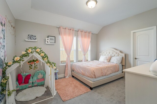 bedroom featuring lofted ceiling and carpet flooring