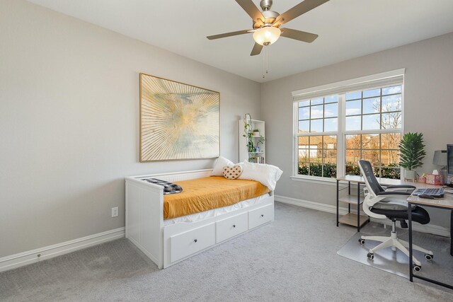 bedroom with light colored carpet, ceiling fan, and baseboards