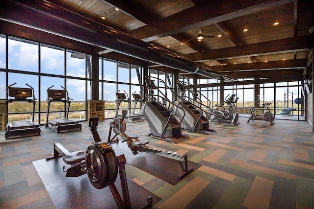 exercise room with wood ceiling, a ceiling fan, a wall of windows, and carpet flooring