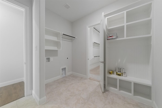 laundry area featuring laundry area, hookup for an electric dryer, visible vents, and baseboards