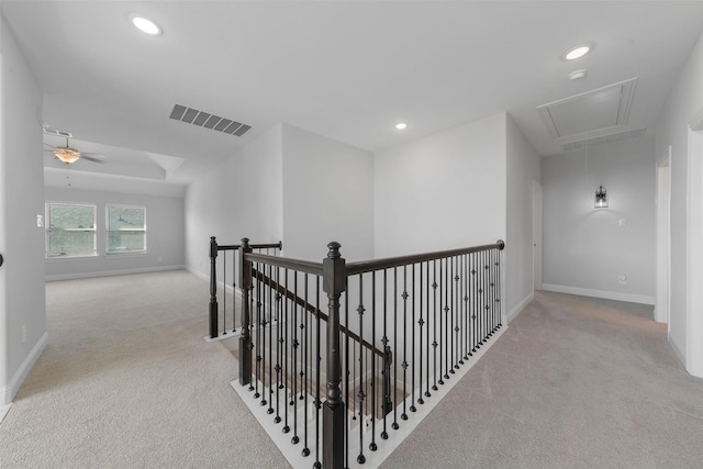 hallway featuring recessed lighting, visible vents, attic access, carpet flooring, and an upstairs landing