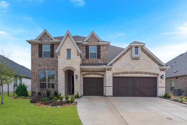 french provincial home with a shingled roof, a front yard, driveway, and an attached garage