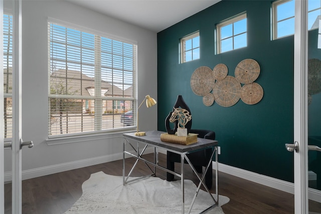 home office with baseboards and wood finished floors