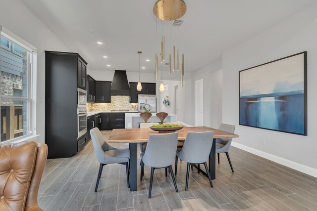 dining area with wood finish floors, visible vents, baseboards, and recessed lighting