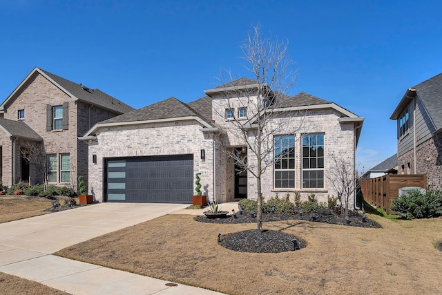 view of front of property with a garage, brick siding, driveway, and a front lawn