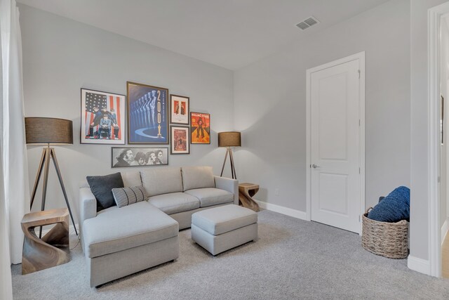 sitting room featuring carpet floors, visible vents, and baseboards