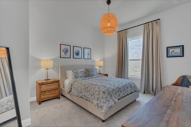 bedroom with light carpet and baseboards