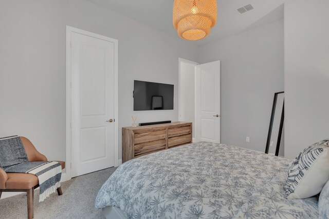 carpeted bedroom featuring visible vents