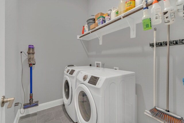 washroom featuring tile patterned flooring, laundry area, independent washer and dryer, and baseboards