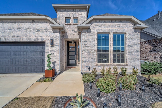 view of front of property with brick siding and an attached garage