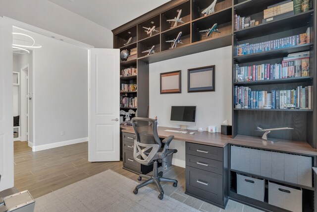 office with light wood-style flooring and baseboards